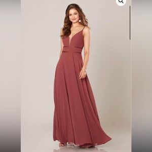This is a burgundy bridesmaids dress. It has never been worn, remains in plastic